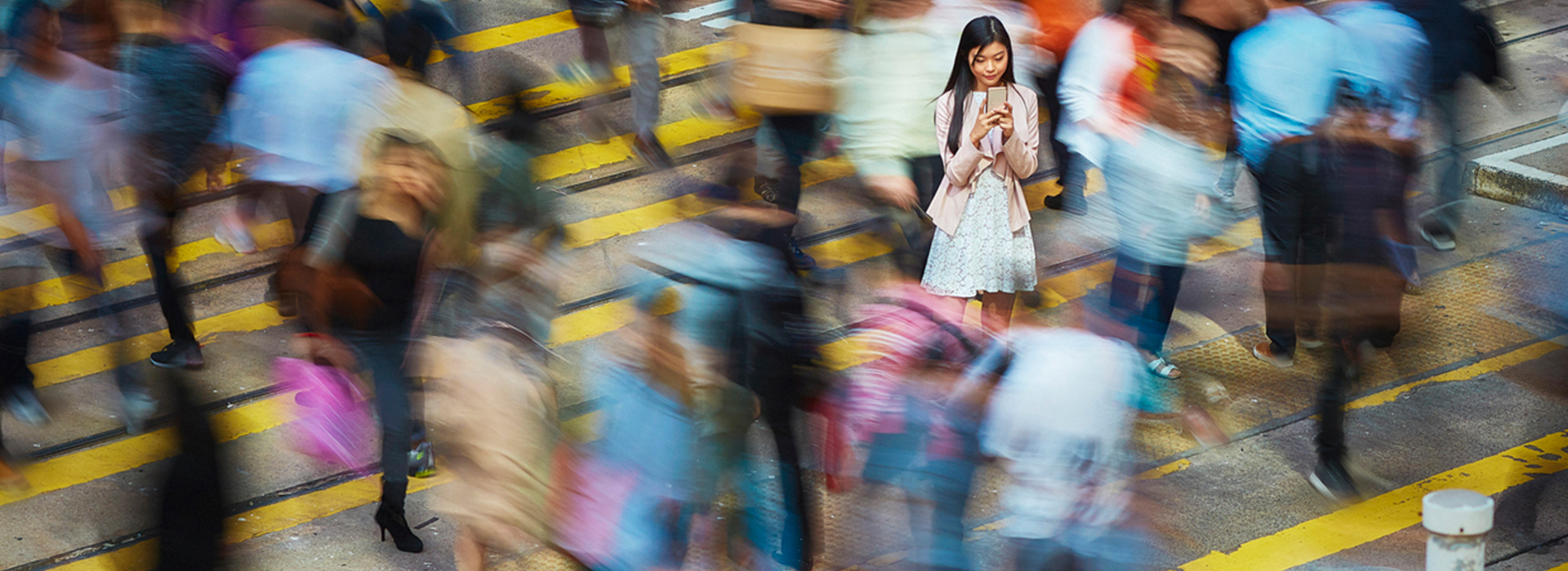 Woman on street using marketing automation application via smart phone mobile device